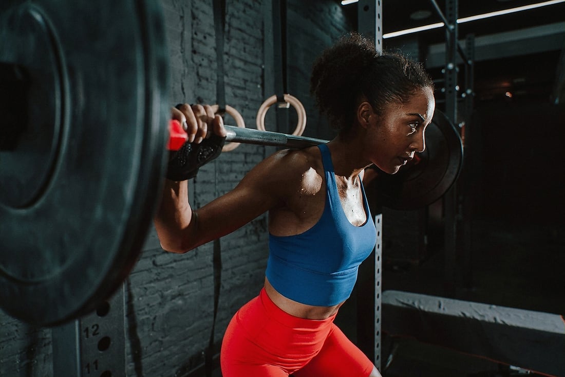 An athlete braced under a loaded barbell at the bottom of a heavy squat.