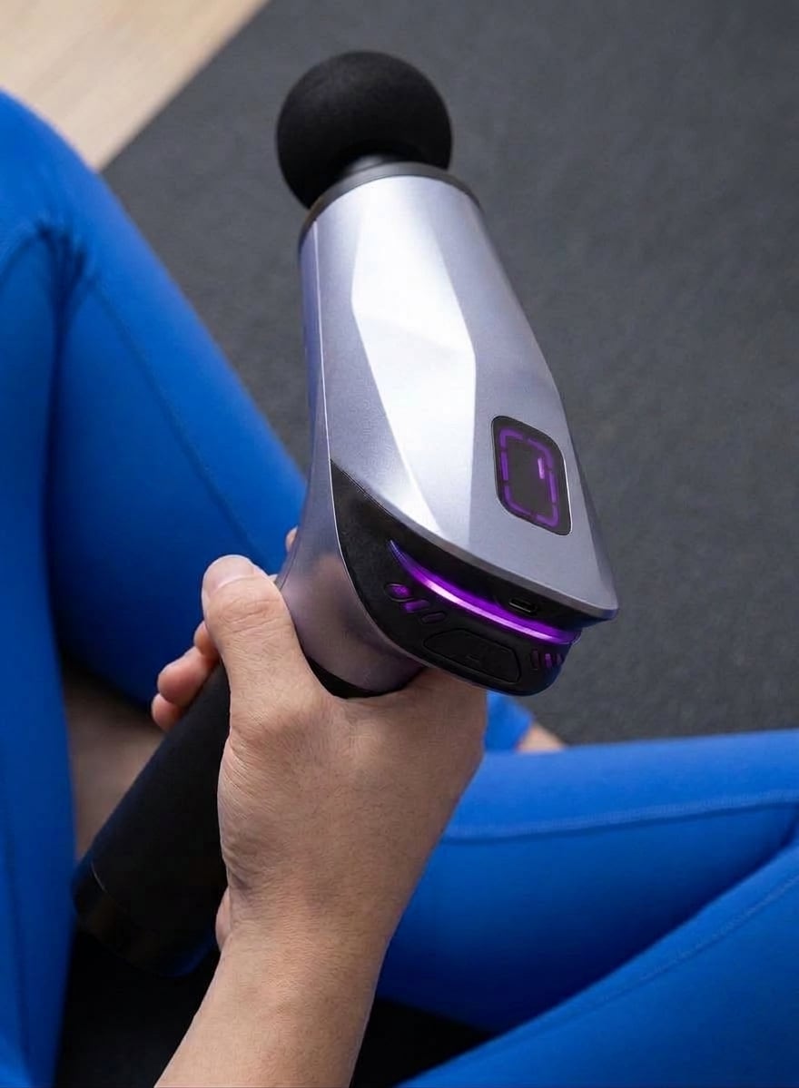 Close view of a hand gripping the EVURON ARC Pro, showing the control face and the illuminated indicator ring.